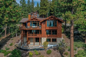 Enjoy a forest view from the upper-level balcony and relax in the covered outdoor area with a table and chairs.