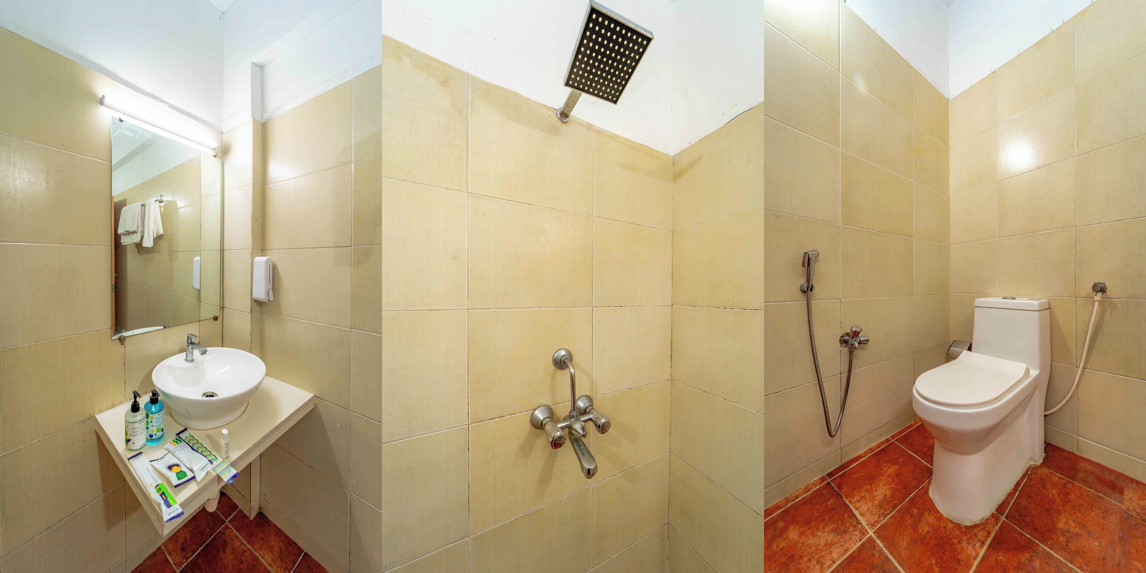 Un baño con lavamanos, espejo, ducha e inodoro.