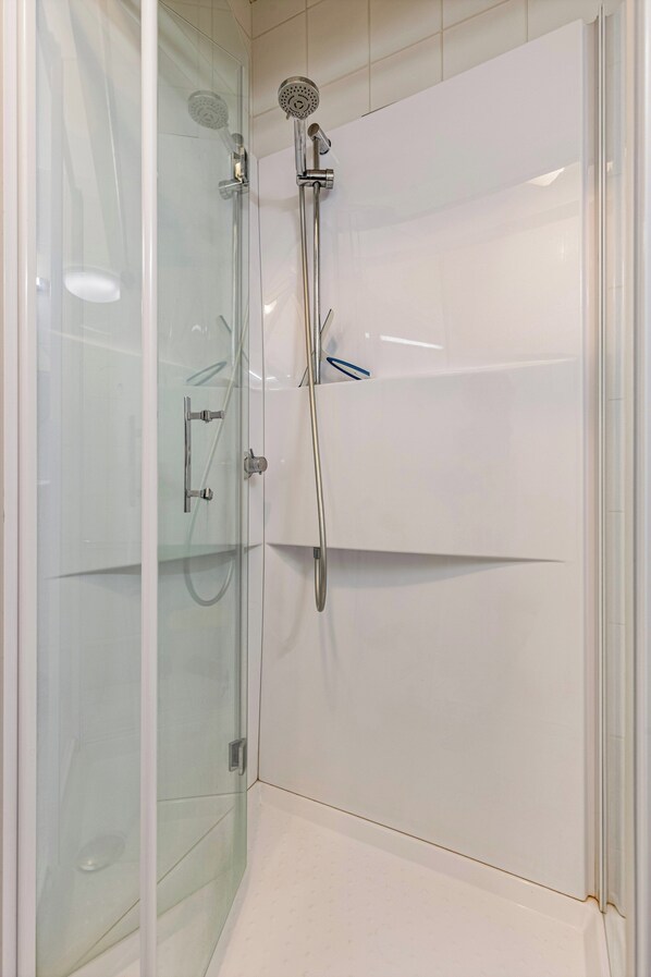 A glass-enclosed shower area with a handheld showerhead and a wall-mounted faucet. - Apartment in Blankenberge Near Seafront (Blankenberge)