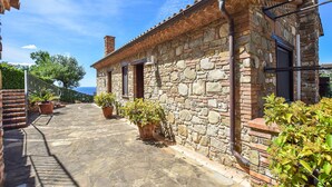 A stone building with a tiled roof, a chimney, and a small window. - Nice apartment in Casal Velino with swimming pool (Casal Velino)