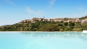 A coastal resort with a large swimming pool, hillside villas, and a prominent tower. - Nice apartment in Casal Velino with swimming pool (Casal Velino)