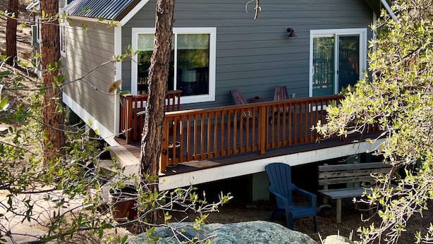 A two-story house with a deck, surrounded by trees and rocks. - Rock Haven - Prescott Cabin Rentals (Prescott)