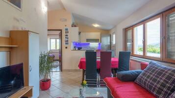 House (Four Bedroom Holiday Home with Pool a) | Living room | 32-inch flat-screen TV with cable channels, foosball, table tennis