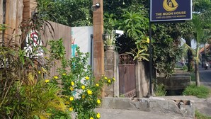 A sign for "The Moon House" with a logo, indicating a cafe, co-living, and co-working space. - The Moon House for Entrepreneurs (Dalung)