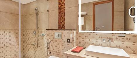 A modern bathroom with a shower, toilet, and sink.