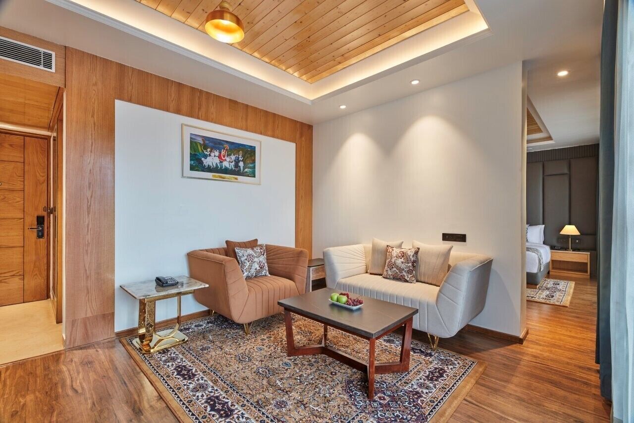 A modern living room with a wooden ceiling, a sofa, a coffee table, and a rug.