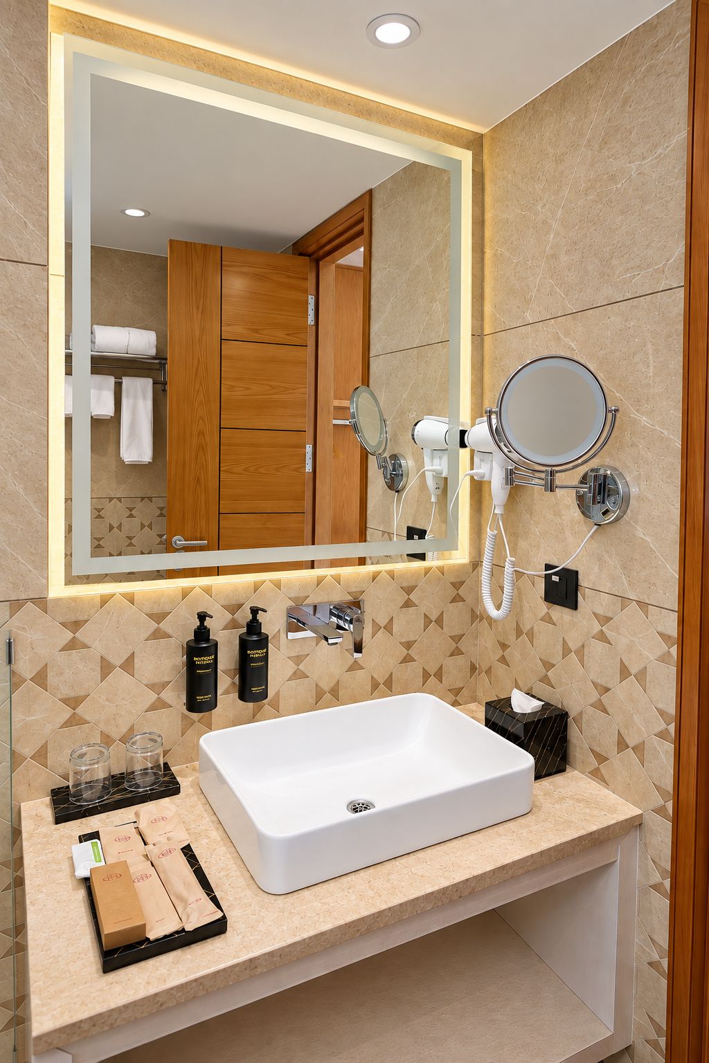 A modern bathroom with a large mirror, a white sink, and a hairdryer mounted on the wall.