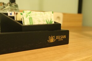 A black wooden box with a logo and text indicating it is from Jelsan Hotel. - ielsan Hotel By Sajiwa (Surabaya)