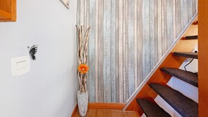 A staircase with wooden steps and a wall with vertical wooden planks. - Holiday Apartment 'Op'nböhn' with Shared Garden and Private Beach Chair (Nordstrand)
