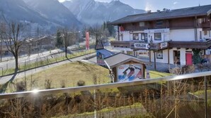 A hotel with a mountain view, a sports center, and a red door.
