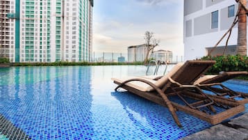 Relax by the pool with a view of the city skyline.