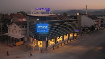 A hotel with a prominent sign reading "ELITEWORLD HOTELS & RESORTS".