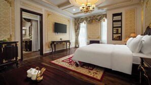 A luxurious bedroom with a large bed, a television, and ornate decor. - Dream Boutique Hotel Da Lat (Xuan Huong - Da Lat)