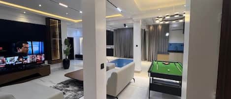 Economy Apartment, Balcony, City View | Living area | Flat-screen TV