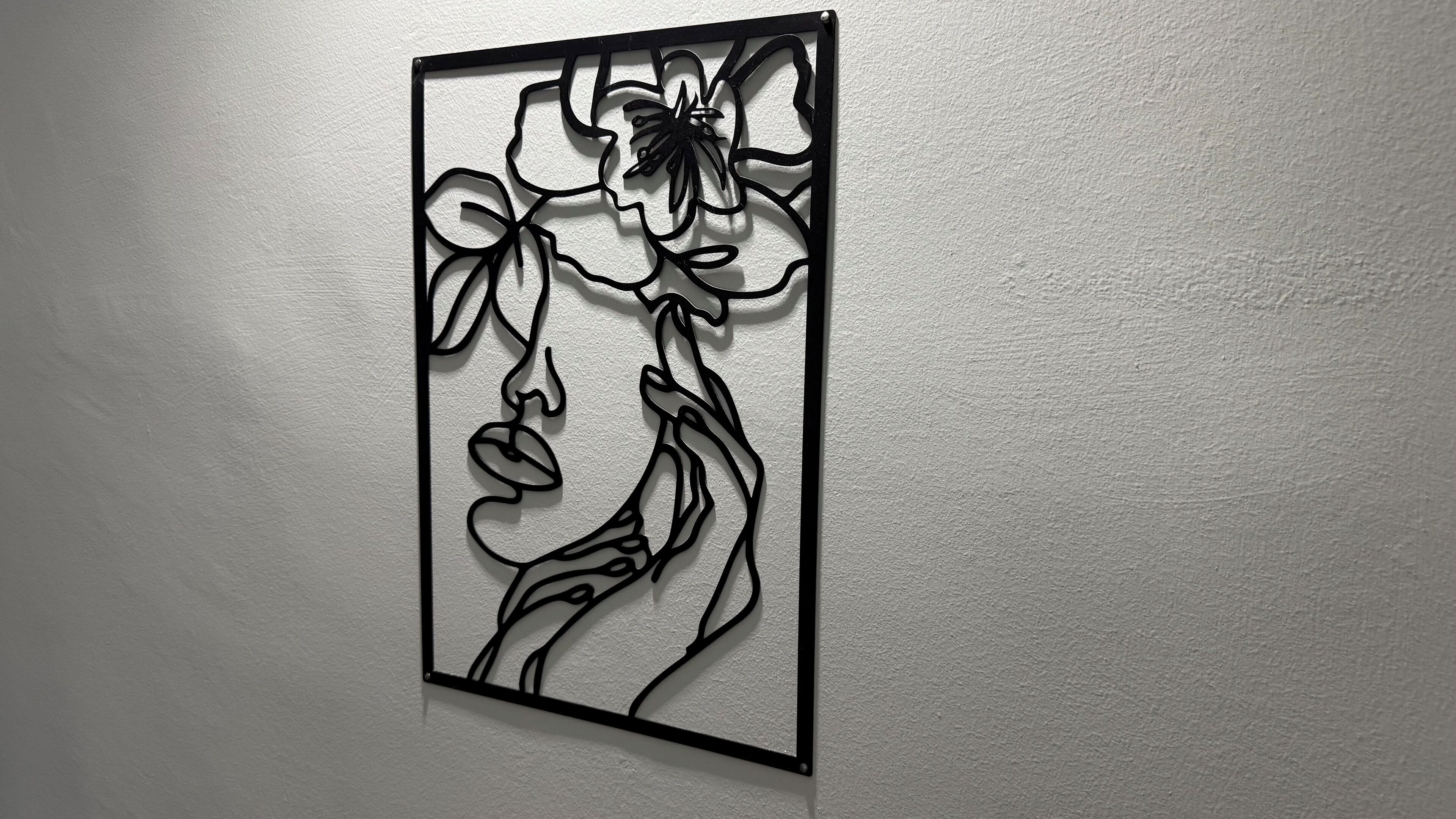 A wall-mounted artwork featuring a stylized floral design.