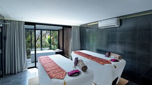 A modern spa room with two massage tables, a large window with curtains, and an air conditioning unit on the wall. - Canary Islands Resort & Spa (Paud)
