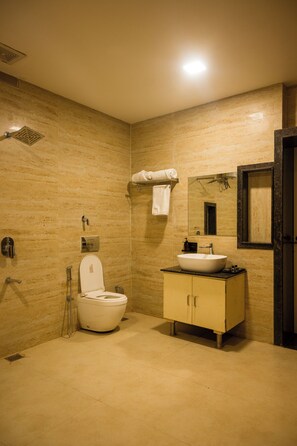 A bathroom with a toilet, sink, mirror, and shower. - AKAY Resort & Villas (Rajnandgaon)