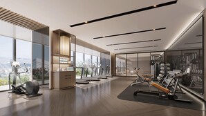 Un gimnasio moderno con cintas de correr, máquinas de pesas y un amplio ventanal con vistas a la ciudad.