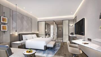 A modern hotel room with a large bed, a desk, a chair, and a TV.
