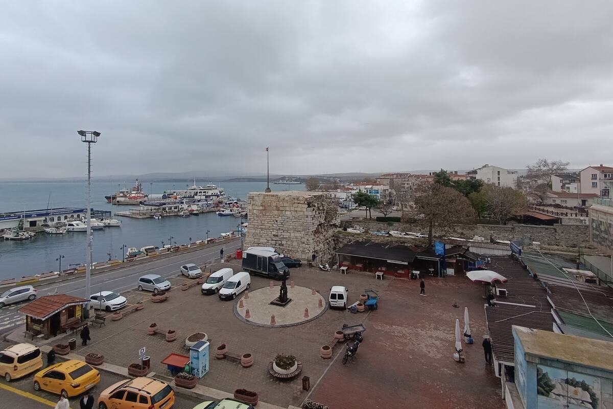 A marina with boats docked, a roundabout, and a mix of commercial and residential buildings.