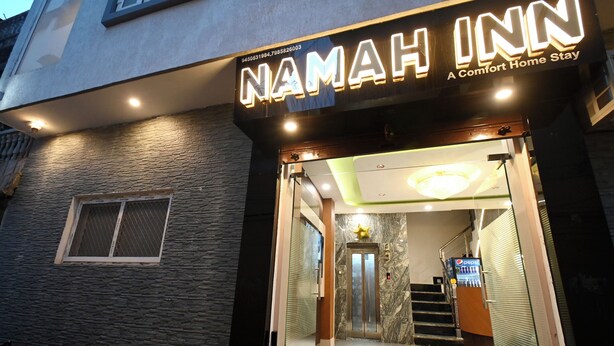 A hotel entrance with a glass facade, a visible elevator, and a Pepsi vending machine. - Namah Inn (Varanasi)