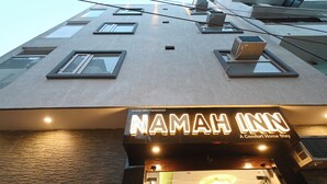 A building with a sign for 'NAMAH INN' indicating it is a hotel. - Namah Inn (Varanasi)