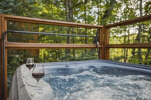 Soak your cares away in the private hot tub while enjoying the peaceful wooded surroundings.