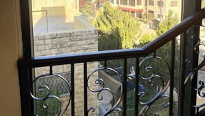 A balcony with wrought iron railings and a view of surrounding buildings. - mount houssein (Amman)