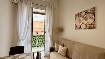 Deluxe Apartment, City View | Living area | Flat-screen TV