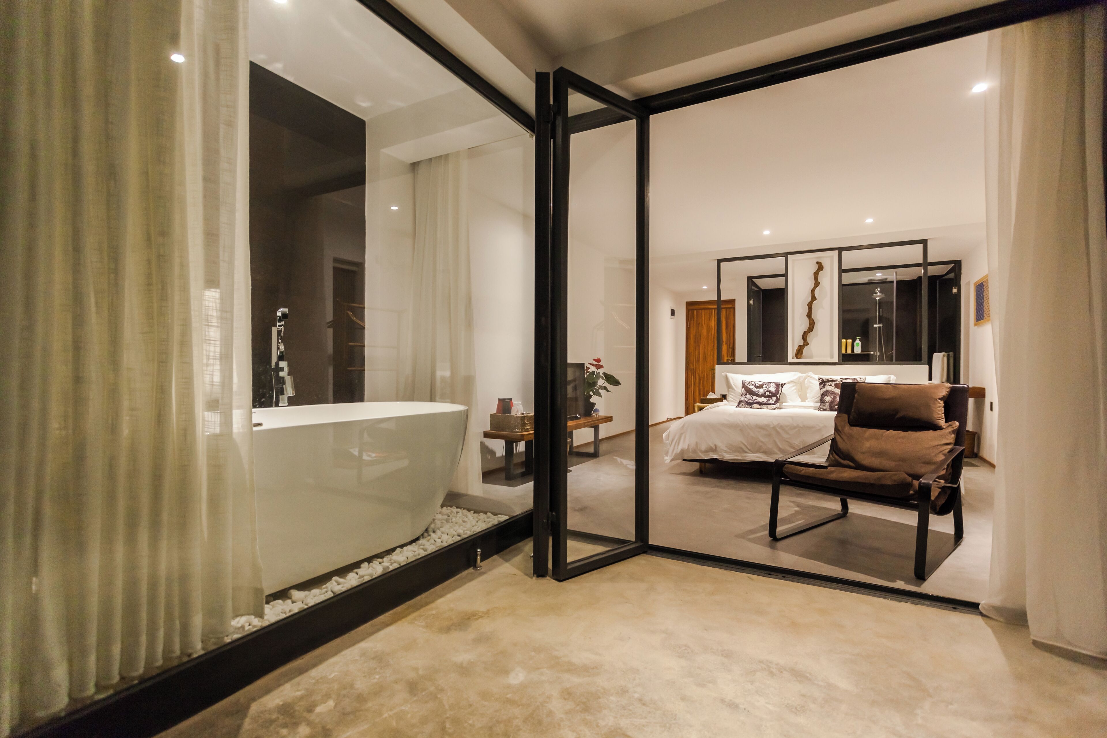 A modern bathroom with a large bathtub, a glass shower enclosure, and a visible toilet.