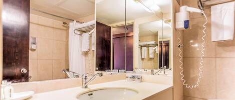 A bathroom with a sink, mirror, towel rack, and a hairdryer.