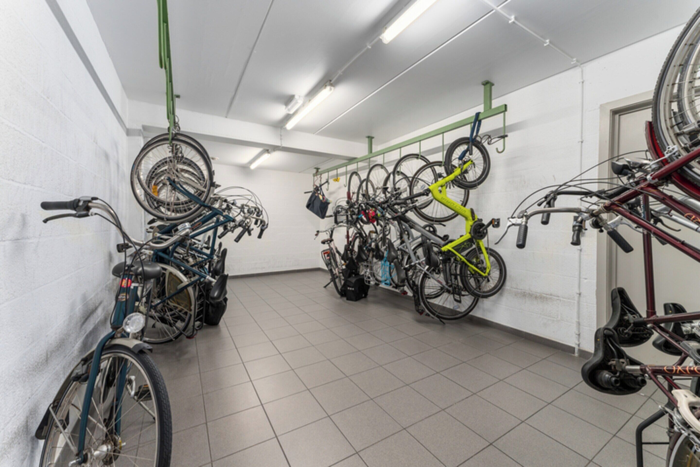 A bike storage area with multiple bicycles and racks.