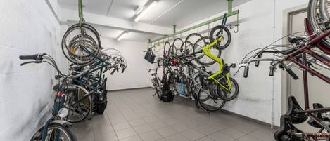 A bike storage area with multiple bicycles and racks.