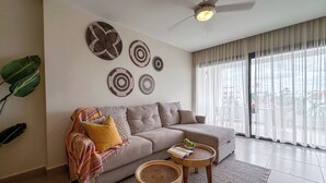 A modern living room with a grey sofa, a coffee table, and decorative wall art.
