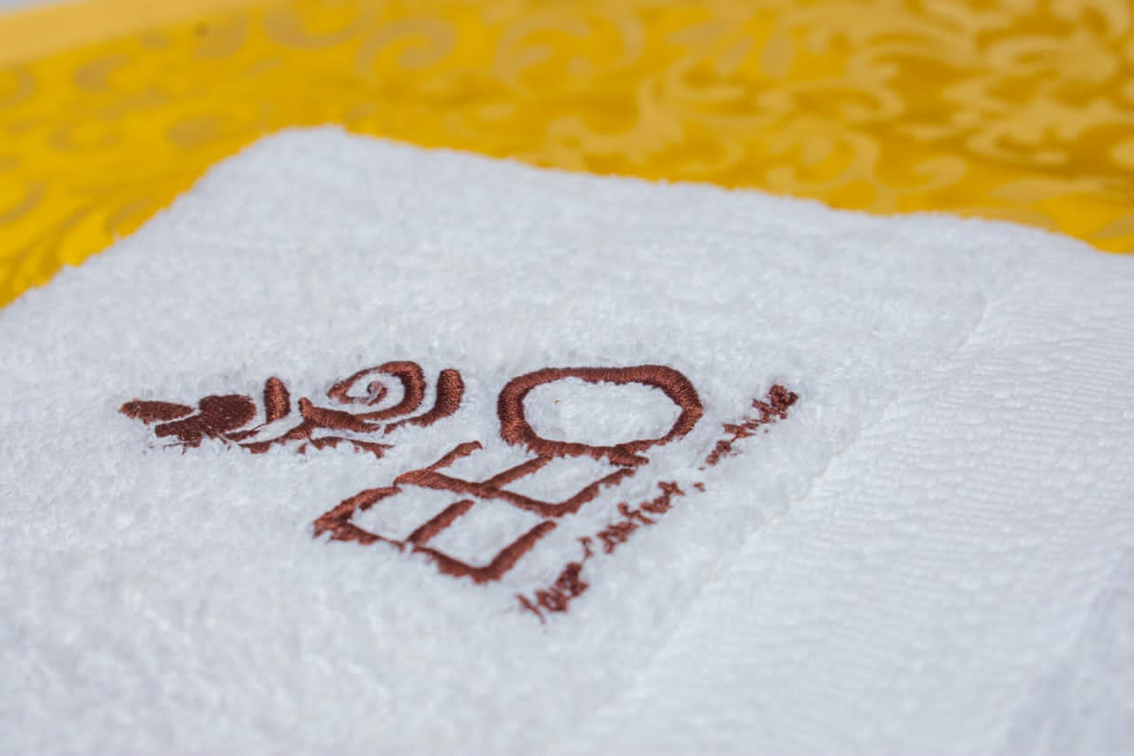 A white towel with embroidered text.