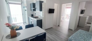 Enjoy a meal at the dining table, cook in the kitchenette, or relax in front of the flat-screen TV.