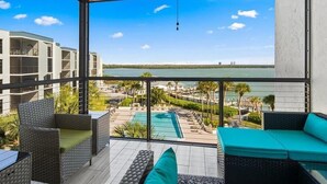 Un balcón con vista a una piscina y una extensión de agua.