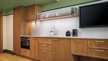 A kitchen with wooden cabinets, a stainless steel sink, and a built-in oven.
