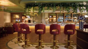 A bar area with red bar stools and a counter. - The July London Victoria (London)