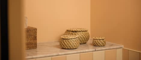Wicker baskets on a bathroom countertop.