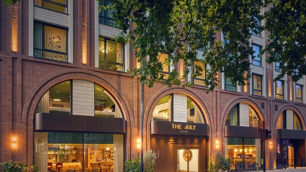 A hotel with arched windows and a sign reading "The July Victoria". - The July London Victoria (London)