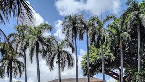 A large, colonial-style building with a symmetrical facade, multiple balconies, and a central entrance. - Modern 2-bedroom Retreat Near Beach Airport (Fort Lauderdale)