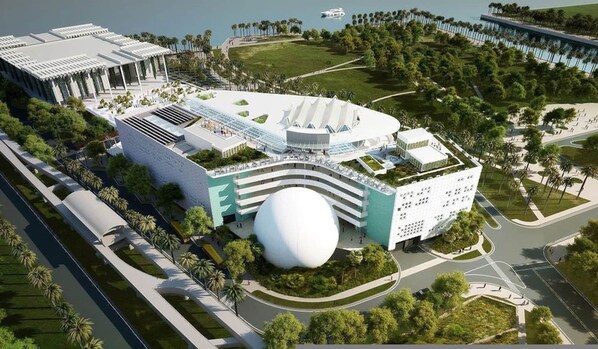 A modern hotel with a unique spherical building, surrounded by lush greenery and a marina. - NEW Top Location King bed Free Parking (Miami)