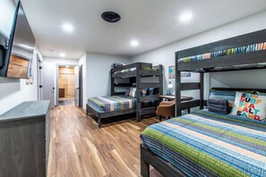 A compact room with bunk beds, a desk, and a chair. - Luxury on Ocean Drive - Sleeps 28 (Corpus Christi)