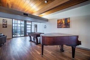 A spacious room with a wooden ceiling, a foosball table, a pool table, and a piano. - Luxury on Ocean Drive - Sleeps 28 (Corpus Christi)