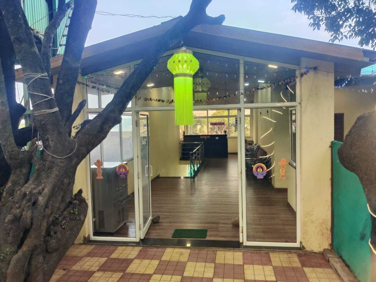 A building with a reception area, a staircase, and a green door.