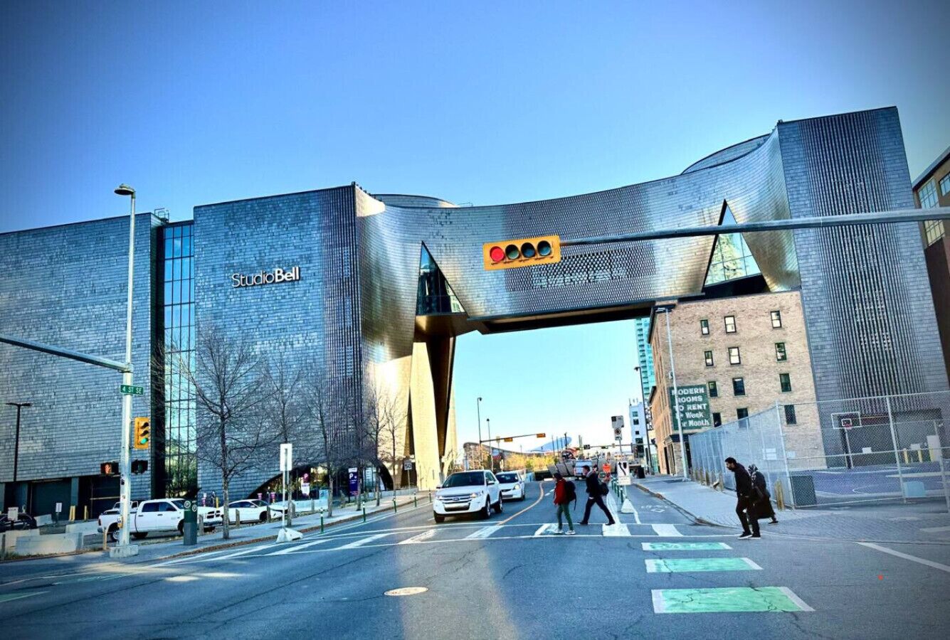 A modern building with a distinctive curved entrance and a Studio Bell sign.