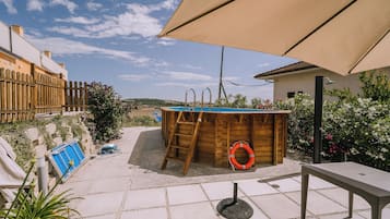 Seasonal outdoor pool, open 9:00 AM to 8:00 PM, pool umbrellas