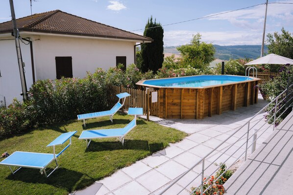 Seasonal outdoor pool, open 9:00 AM to 8:00 PM, pool umbrellas