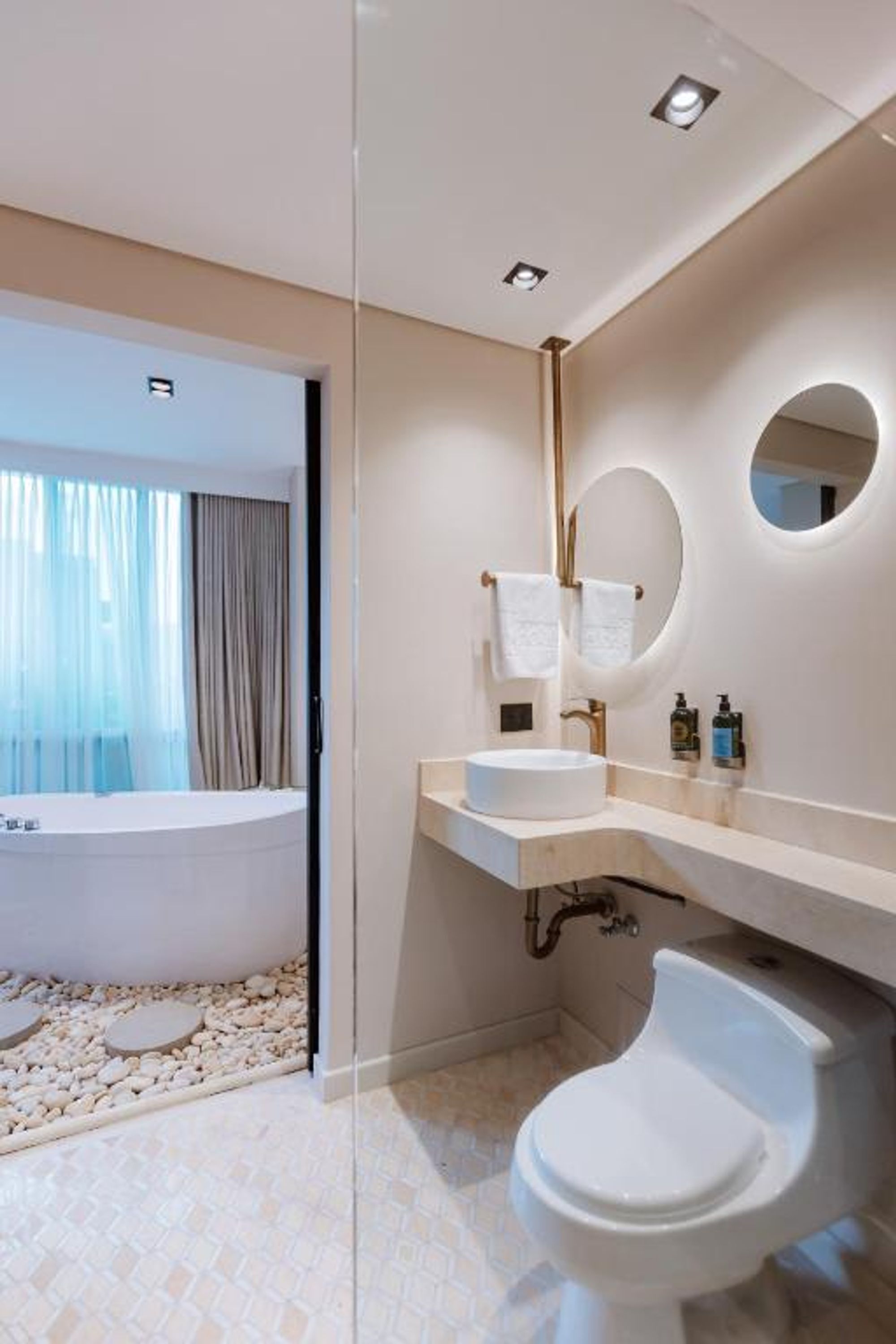 A modern bathroom with a bathtub, a sink, and a toilet.